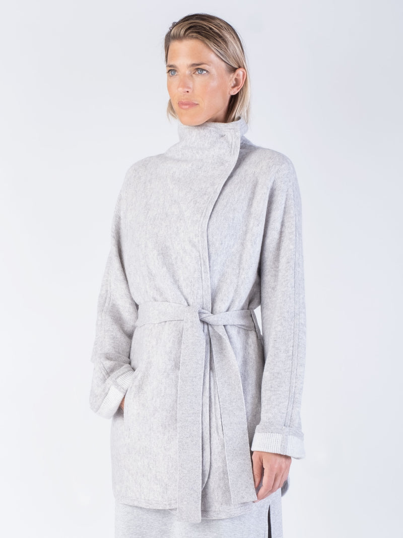 Model wearing a light grey two pockets jacket with a waist tie